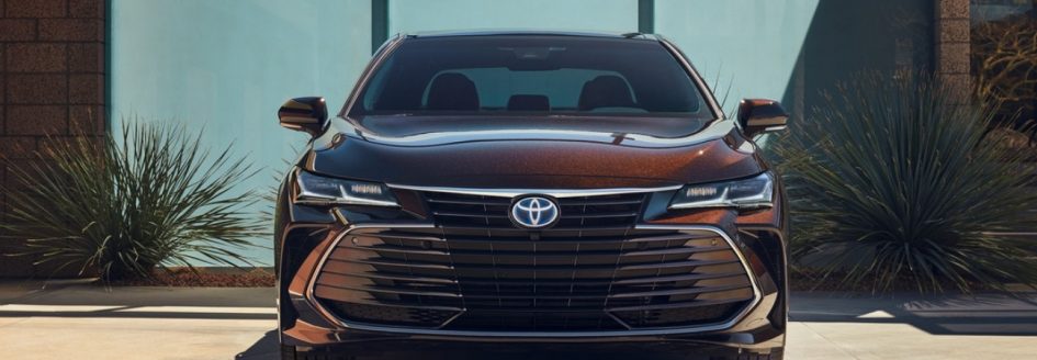 New 2019 Toyota Avalon in opulent amber parked in front of a modern home